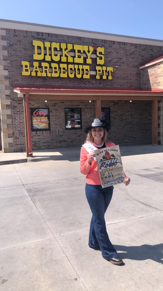 rodeo queen with poster at local barbecue pit